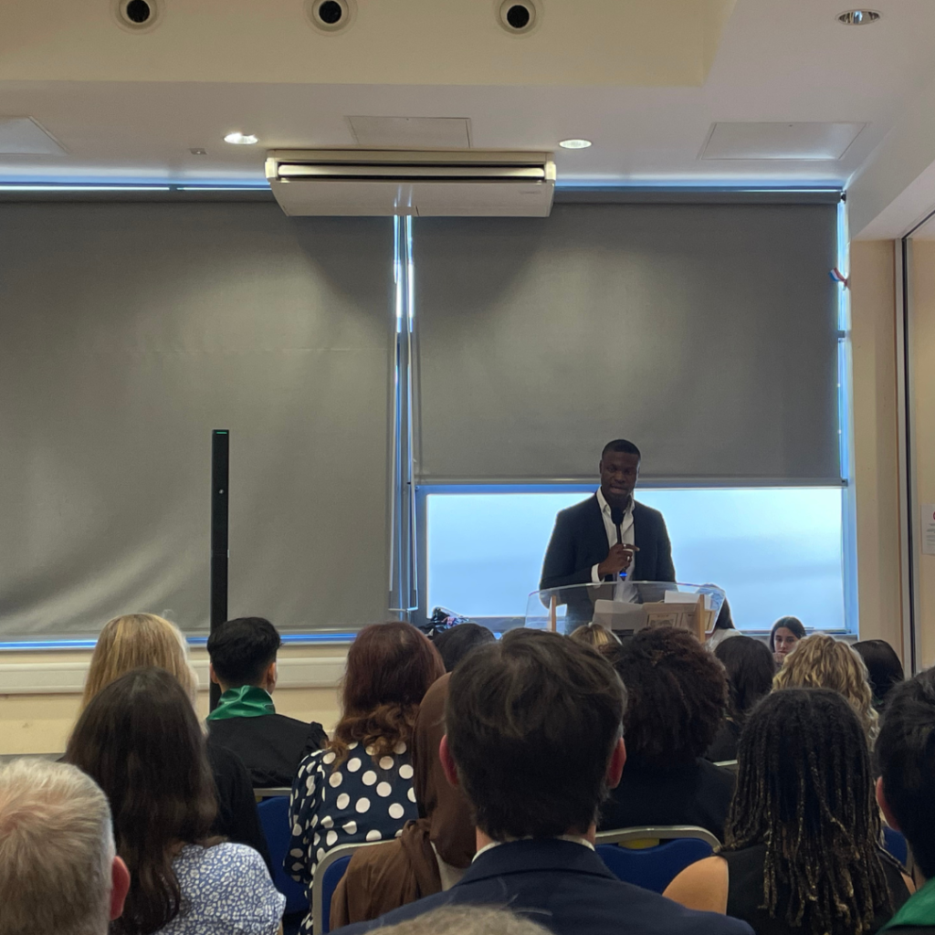 A picture of alumni Anthony giving his speech