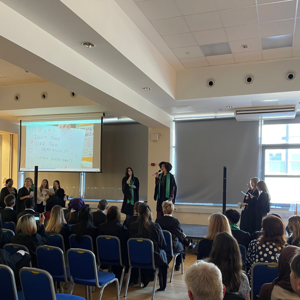 A picture of two students doing a duet during graduation