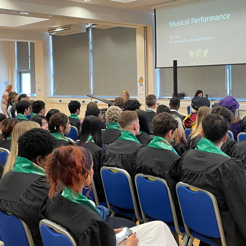 A picture of a student playing the piano at graduation.