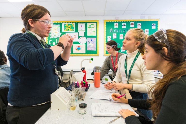 Teacher discussing work with students